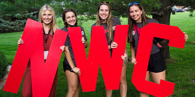 Students holding NWC letters