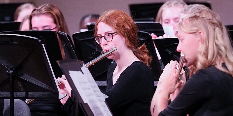 Student clarinetist performs on stage with the Symphonic Band