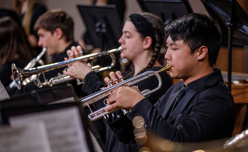 Student playing trumpet in concert