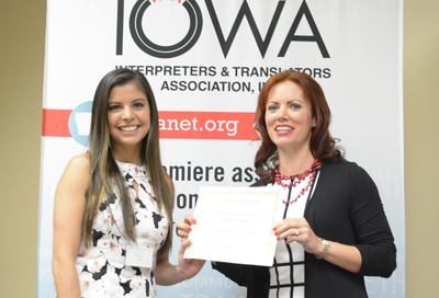 Michelle Palafox, left, receives the Promising ITR Professional Scholarship from Jeana Clark, president of the Iowa Interpreters and Translators Association.