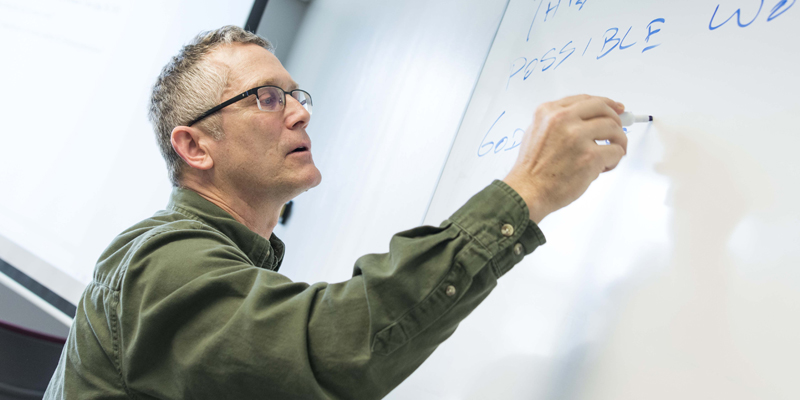 Dr. Mike Kugler writing on a whiteboard