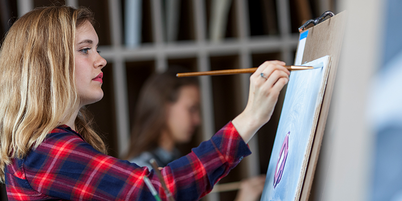 Faith Tyrrell painting in the studio