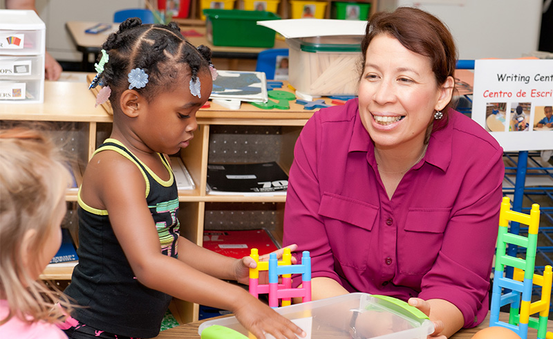 Teacher working with young students