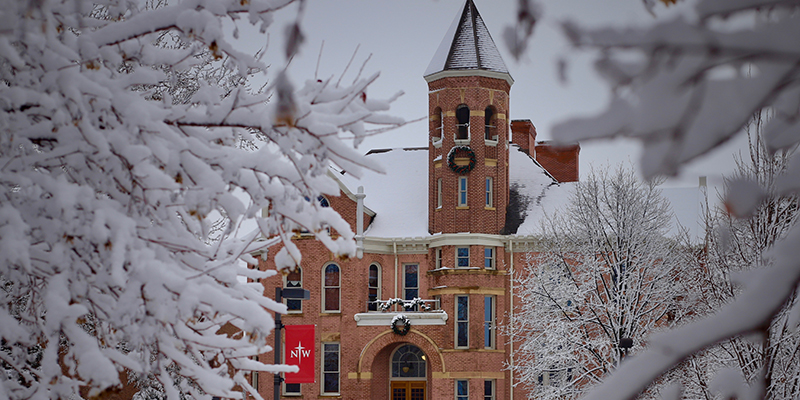 Zwemer Tower surrounded by snow covered trees