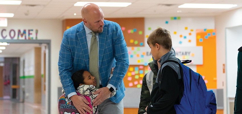 Principal greeting students