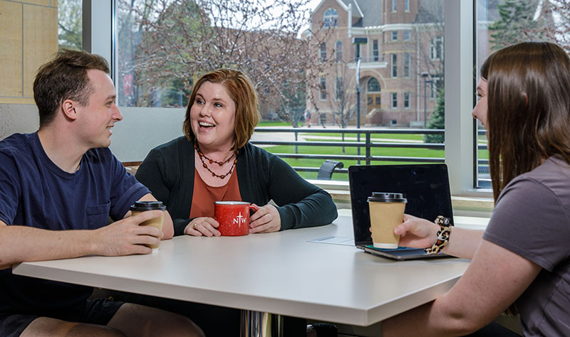 Northwestern College social work professor Val Stokes talks with students at the Common Grounds.